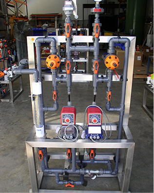 Standardised caustic dosing SKID with Iwaki EH-E solenoid dosing pumps for water treatment plant.